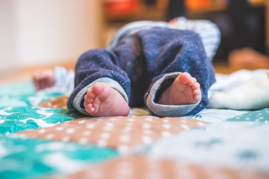 Close up of newborn baby feet on baby blanket