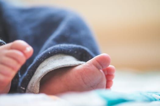 Close up of newborn baby feet on baby blanket