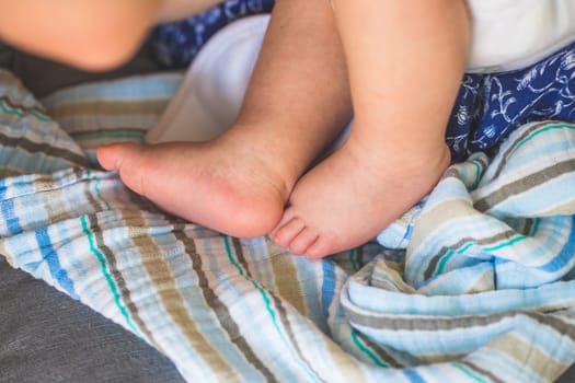 Close up of newborn baby feet on baby blanket