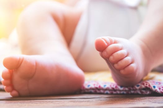 Close up of newborn baby feet, outdoors on baby blanket