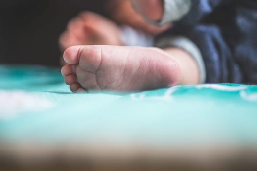Close up of newborn baby feet on baby blanket