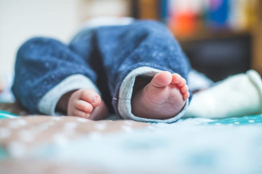Close up of newborn baby feet on baby blanket