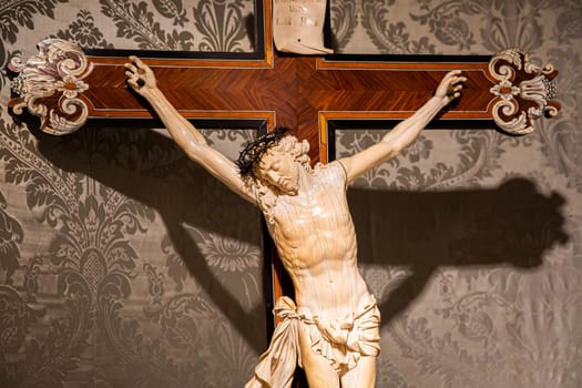 TURIN, ITALY - CIRCA MAY 2021: old crucifix made of wood and ivory (1750). Jesus Christ symbol of resurrection and life after the death.