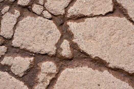 Cracks in the surface of the pavement of a weathered road
