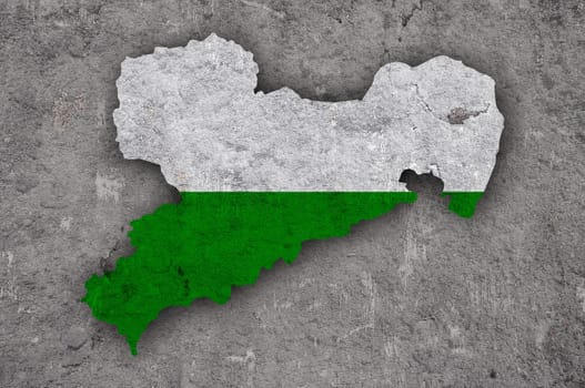 Map and flag of Saxony on weathered concrete