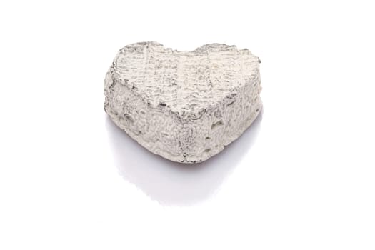 Goat cheese with heart shape white isolated