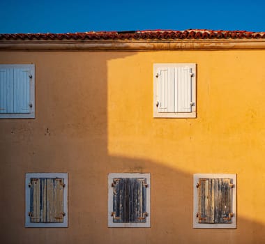 Window of old building in Montenegro, Europe. City architecture and details. Blue sky in background.
