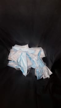 Single-use surgical face mask container. Environmental pollution in nature concept