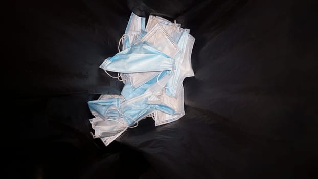 Single-use surgical face mask container. Environmental pollution in nature concept