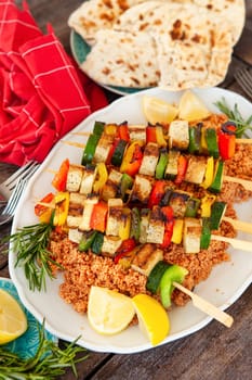 Grilled vegetable skewers with soy on tomato couscous