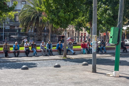 Men on a bench in Echaurren Square in Valparaiso, Chile