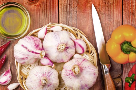 The Culinary background garlic, pepper on a wooden table