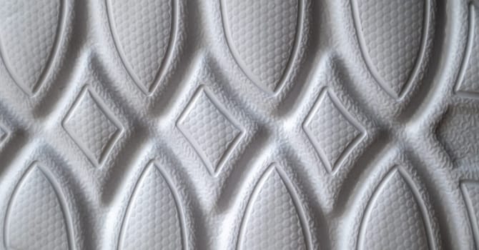 The outsole of new white sneakers. Rubber sole for men's shoes. Sole for sports and walking shoes. The texture of the material of sports shoes.
