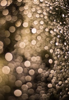 Abstract blurred dark brown light from water drop at the windscreen bokeh background