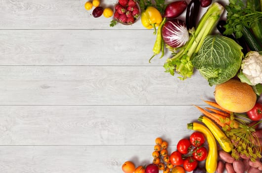 studio photo of different fruits and vegetables on wooden table