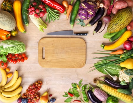 Healthy food background and Copy space / studio photography of wooden board surrounded by fresh vegetables on wooden table