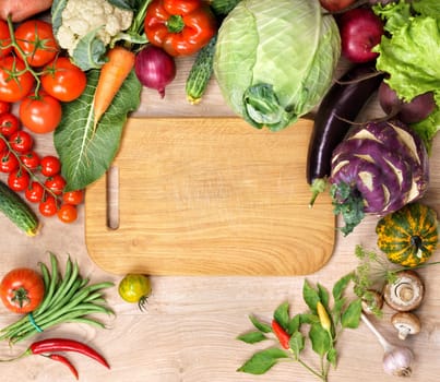 Healthy food background and Copy space / studio photography of open blank ring bound notebook surrounded by a fresh vegetables and pencil on old wooden table