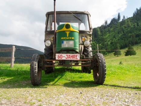 Nesselwang, Germany - July 23, 2020: Side view of a green perfectly restored Deutz tractor away from a veteran tractor.