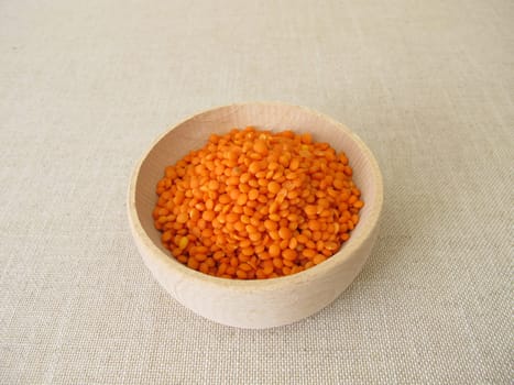 Red lentils in a wooden bowl