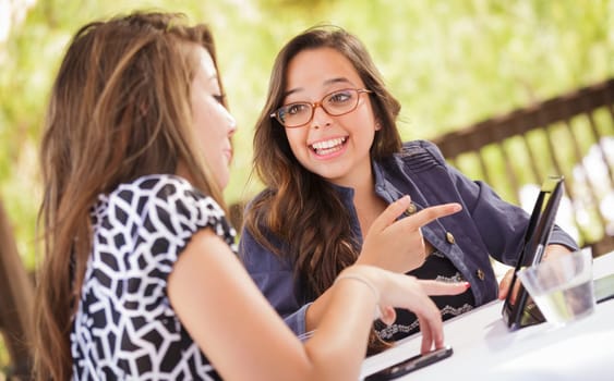 Expressive Young Adult Girlfriends Using Their Computer Electronics Outdoors