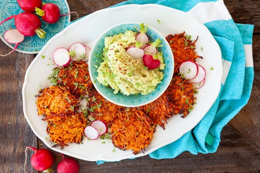 Savory sweet potato fritters with avocado dip and fresh radish