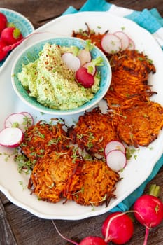 Savory sweet potato fritters with avocado dip and fresh radish