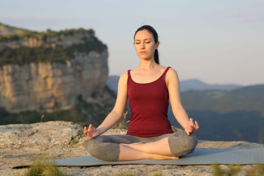 Mixed race woman doing yoga exercise in the mountain