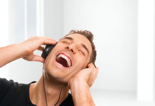 handsome smiling man listening the music.