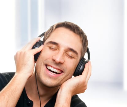 handsome smiling man listening the music.