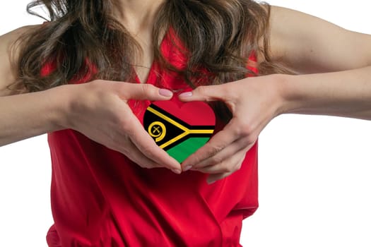Love Vanuatu. The woman holds a heart in the form of the flag of Vanuatu on her chest. Concept of patriotism.