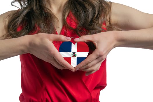 Love Dominican Republic The woman holds a heart in the form of the flag of Dominican Republic on her chest. Concept of patriotism.
