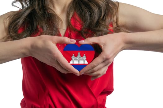 Love Cambodia The woman holds a heart in the form of the flag of Cambodia on her chest. Concept of patriotism.
