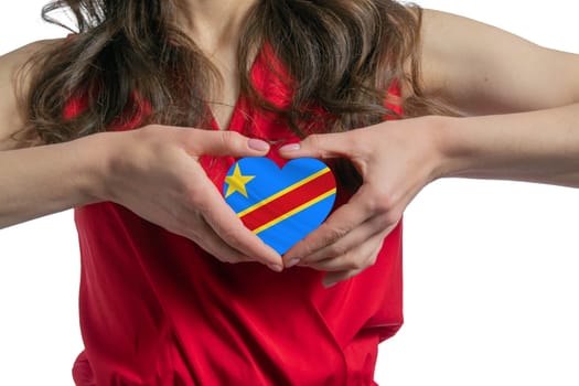 Love Democratic Republic of the Congo The woman holds a heart in the form of the flag of Democratic Republic of the Congo on her chest. Concept of patriotism.