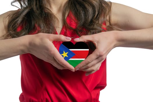 Love South Sudan. The woman holds a heart in the form of the flag of South Sudan on her chest. Concept of patriotism.