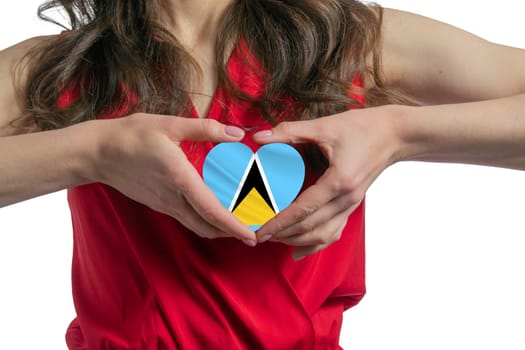 Love Saint Lucia. The woman holds a heart in the form of the flag of Saint Lucia on her chest. Concept of patriotism.