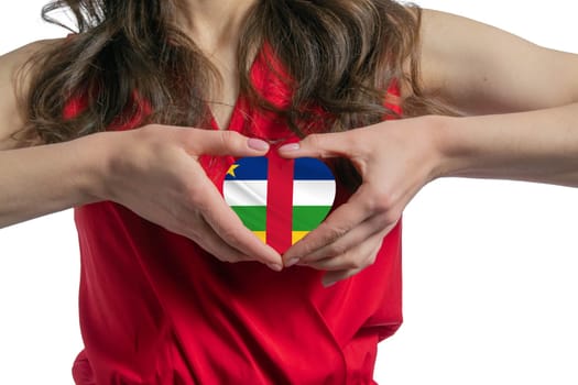 Love Central African Republic. The woman holds a heart in the form of the flag of Central African Republic on her chest. Concept of patriotism.