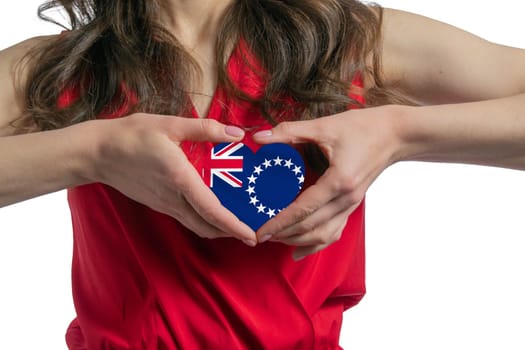 Love Cook Islands. The woman holds a heart in the form of the flag of Cook Islands on her chest. Concept of patriotism.