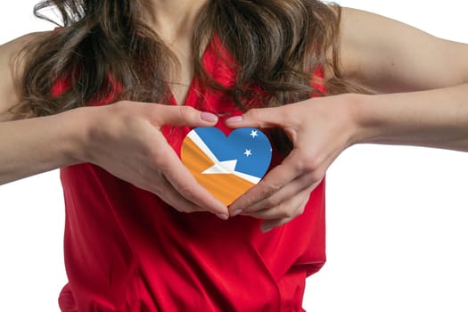 Love Argentine Antarctica. The woman holds a heart in the form of the flag of Argentine Antarctica on her chest. Concept of patriotism.