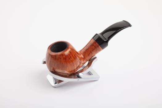 Beautiful brown Pipe on a stand on white background