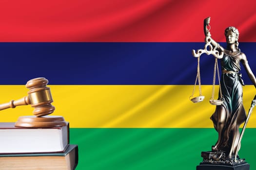 Law and justice in Mauritius. Statue of themis and the gavel of the judge against the background of the flag of Mauritius. Law and justice concept.