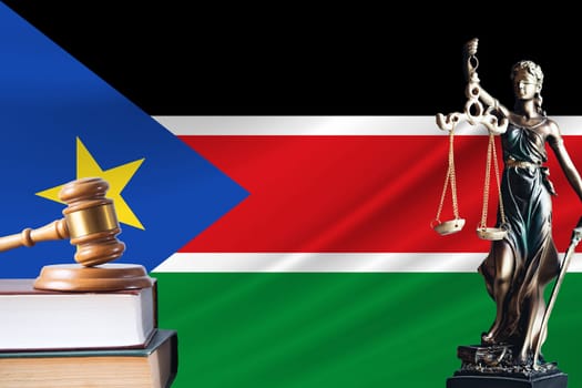 Law and justice in South Sudan. Statue of themis and the gavel of the judge against the background of the flag of South Sudan. Law and justice concept.