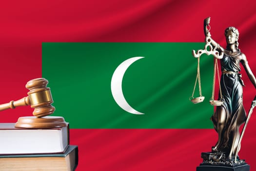 Law and justice in Maldives. Statue of themis and the gavel of the judge against the background of the flag of Maldives. Law and justice concept.