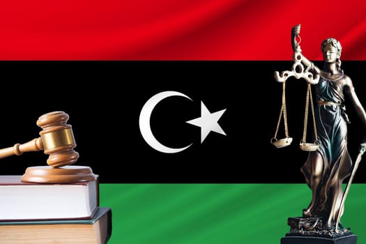 Law and justice in Libya. Statue of themis and the gavel of the judge against the background of the flag of Libya. Law and justice concept.