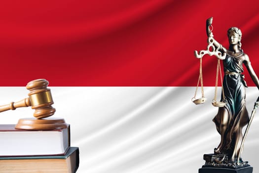 Law and justice in Indonesia Statue of themis and the gavel of the judge against the background of the flag of Indonesia