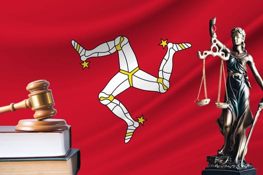 Law and justice in Isle of Man. Statue of themis and the gavel of the judge against the background of the flag of Isle of Man. Law and justice concept.