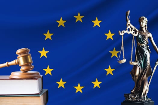 Law and justice in European Union. Statue of themis and the gavel of the judge against the background of the flag of European Union. Law and justice concept.
