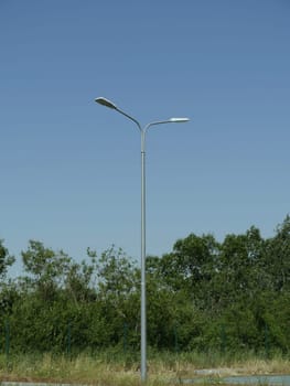 one tall electric lantern in an empty park minimalism