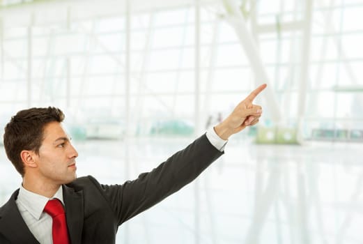 young business man in a suit pointing with his finger