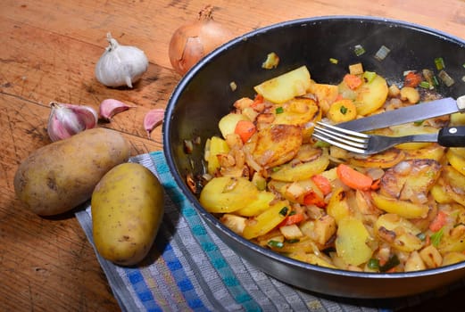 Roast potatoes in a black pan