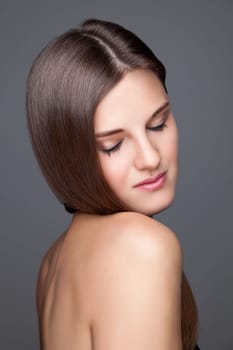 Beautiful young brunette with long straight hair